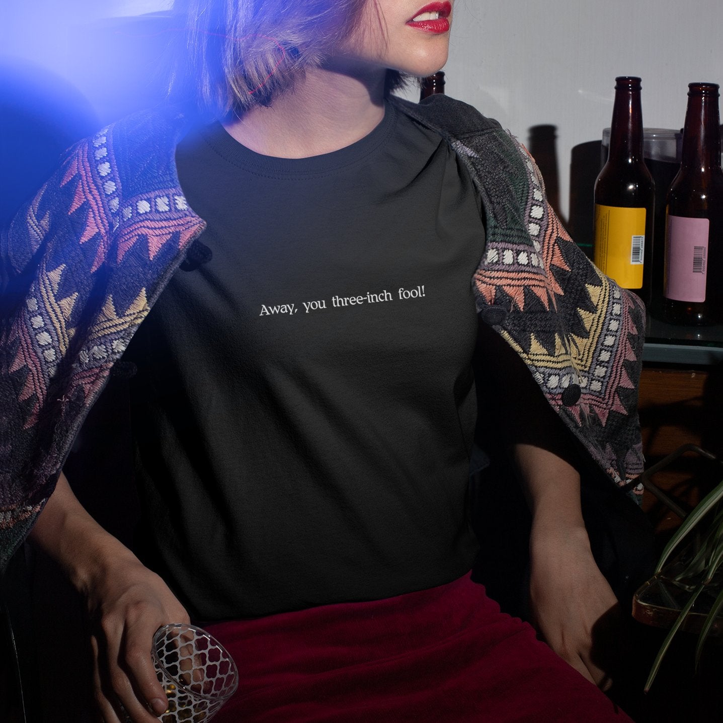 Black witty bard graphic tees featuring Shakespeare insults with a person wearing a patterned shawl indoors