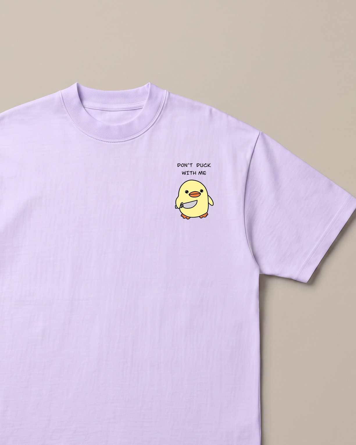 Don't Duck With Me Lavender oversized t-shirt — angry duck holding a knife, front print