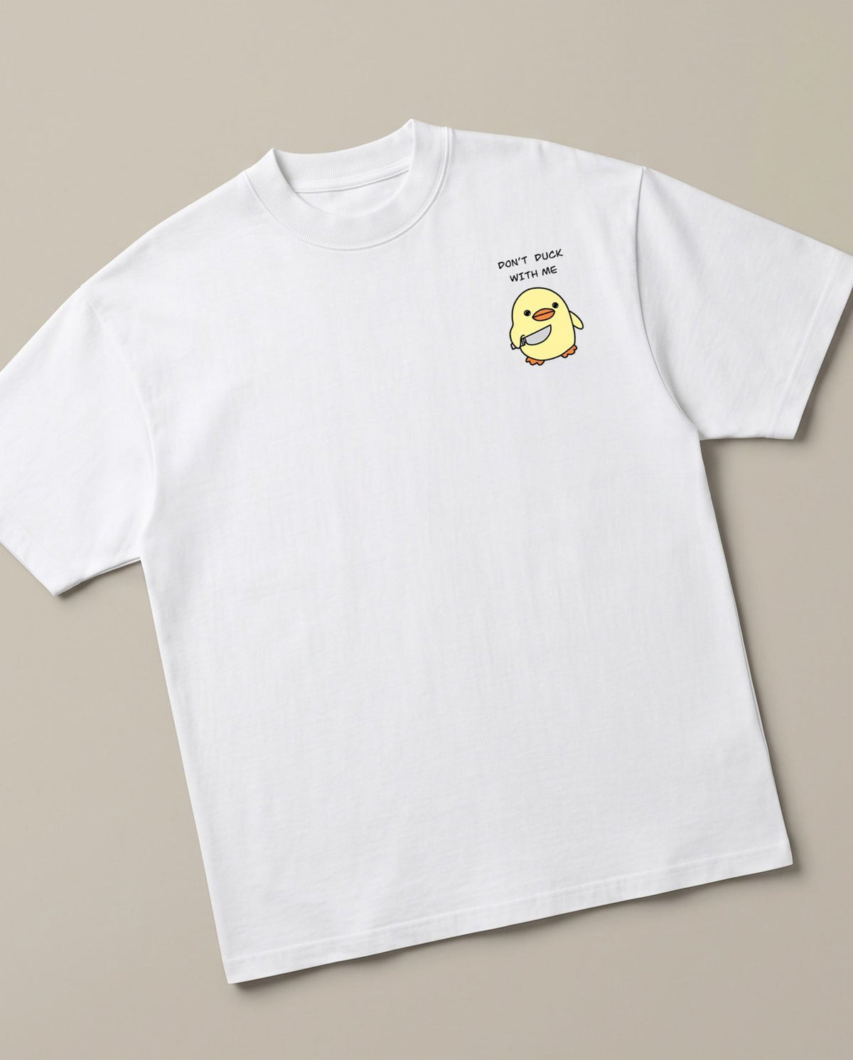 Don't Duck With Me White oversized t-shirt — angry duck holding a knife, angled view
