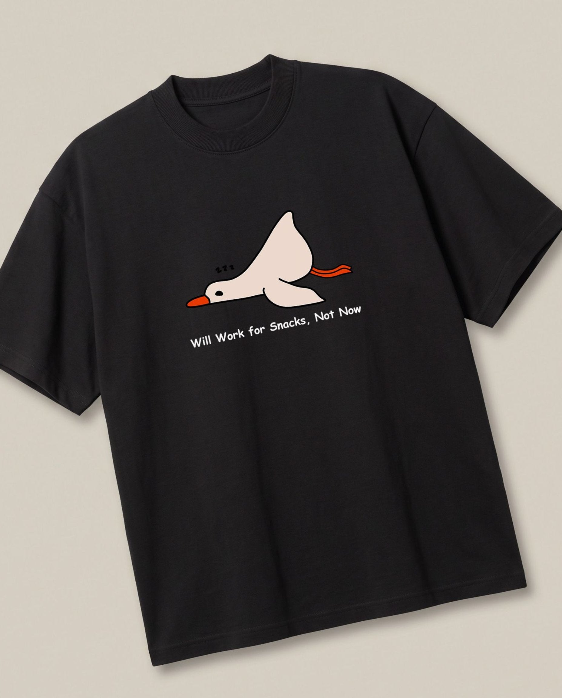 Nap Now, Work Never Black oversized t-shirt — lazy duck, angled view