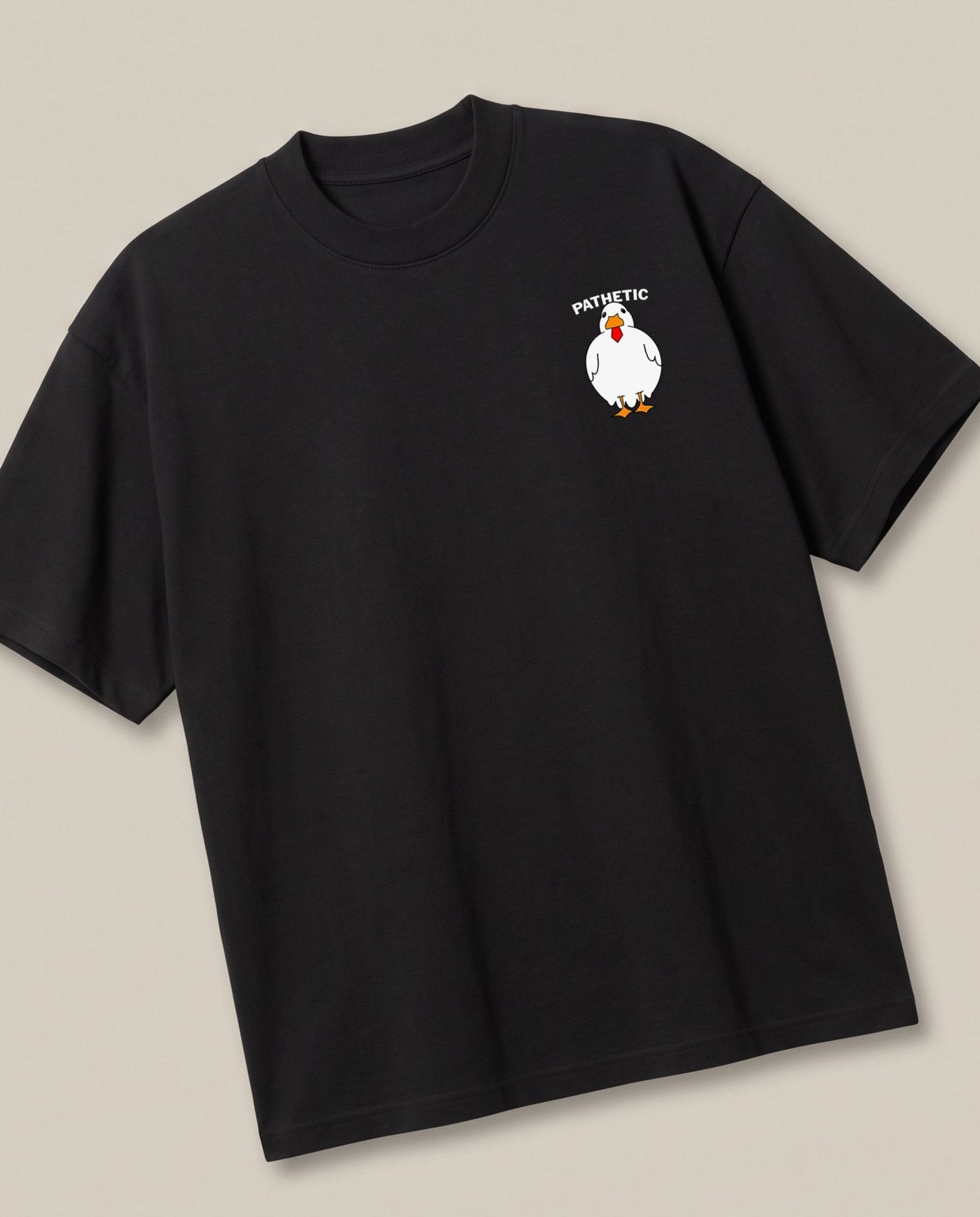 Pathethic Black oversized t-shirt — sarcastic duck, angled view