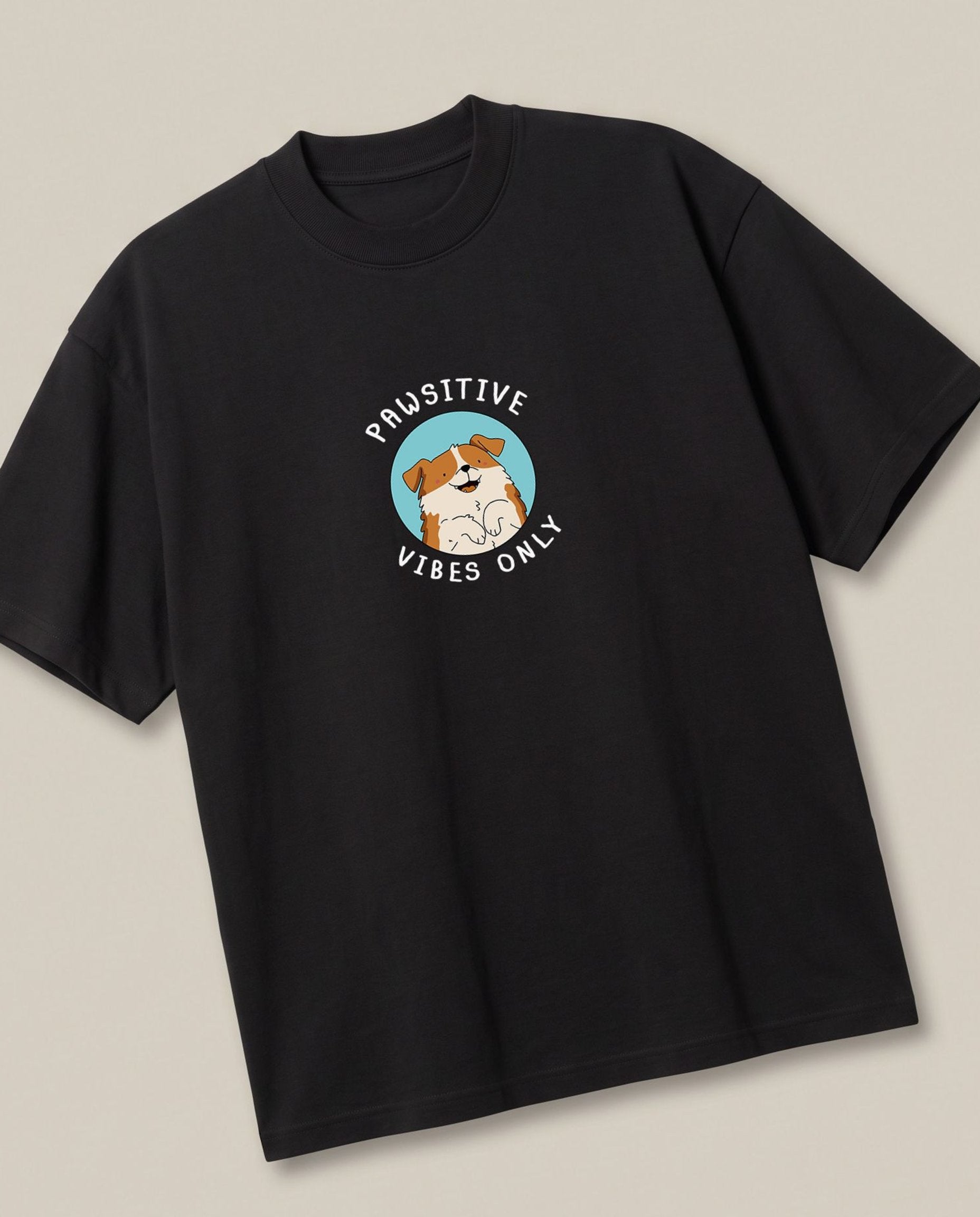Pawsitive Black oversized t-shirt — positive vibes only from the doggy, angled view