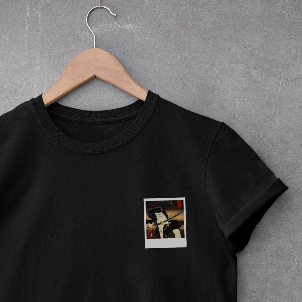 polaroid of Japanese man with sword in mouth on black t-shirt.